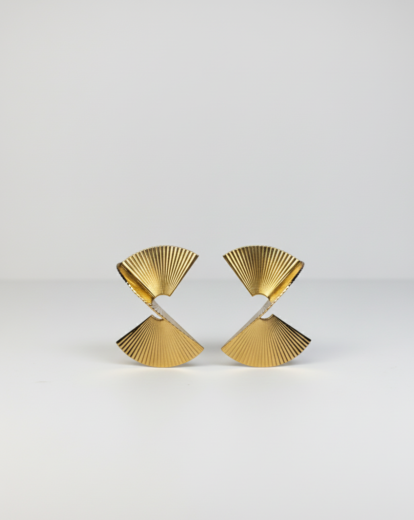 Pair of modern gold fan-shaped stud earrings with ridged texture on white background