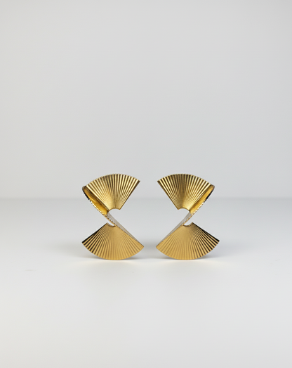 Pair of modern gold fan-shaped stud earrings with ridged texture on white background